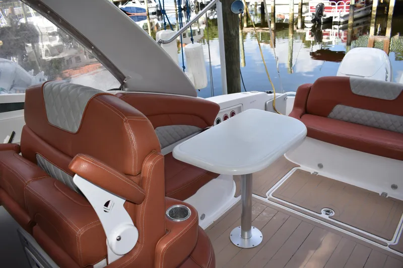 Slide: The Image of 2018 Pronautica 34 boat interior with brown leather seating and white table. - 7
