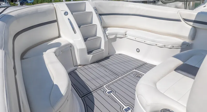 Slide: The Image of 2014 Nor-Tech 390 Sport Cuddy Center Console interior with white seating and gray flooring. - 11