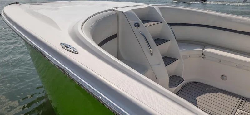 Slide: The Image of 2014 Nor-Tech 390 Sport Cuddy Center Console boat with green hull and sleek design. - 12