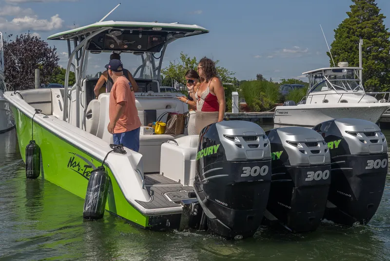 Slide: The Image of 2014 Nor-Tech 390 Sport Cuddy Center Console with Mercury engines, docked with people onboard. - 3