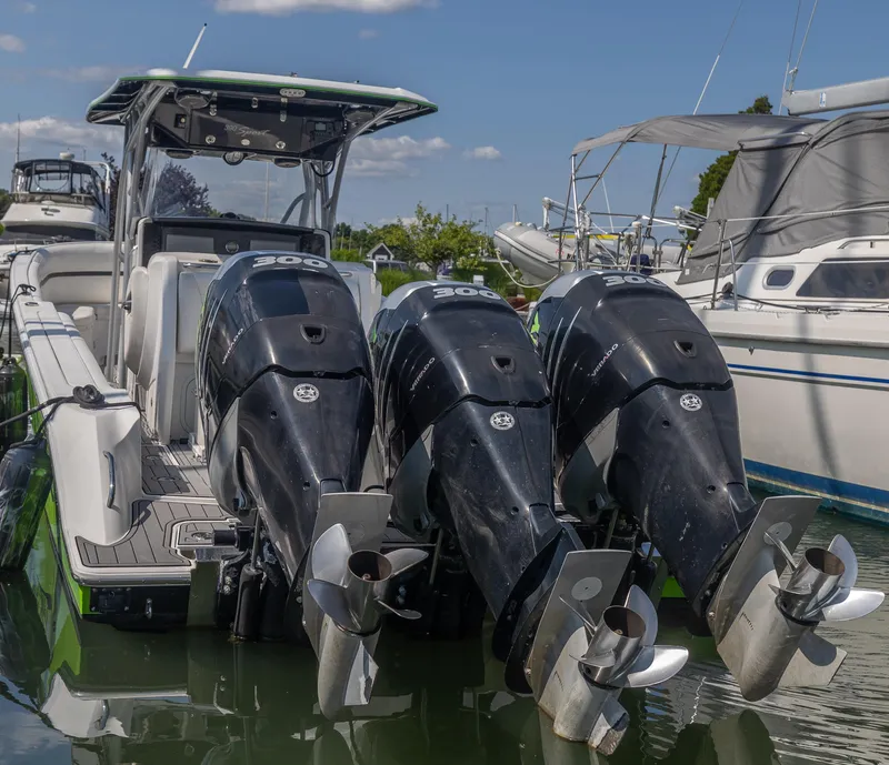 Slide: The Image of 2014 Nor-Tech 390 Sport Cuddy Center Console with triple outboard engines docked. - 4
