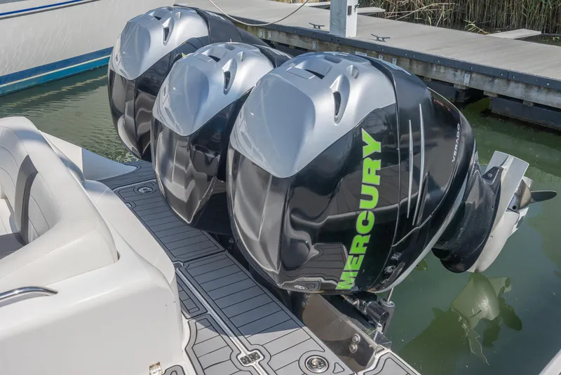 Slide: The Image of 2014 Nor-Tech 390 Sport Cuddy with triple Mercury outboard engines at dock. - 5