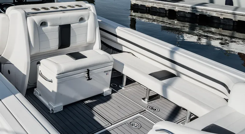 Slide: The Image of 2014 Nor-Tech 390 Sport Cuddy Center Console interior with seating and storage. - 6