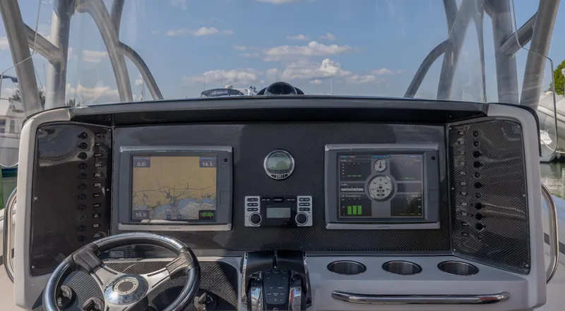 Slide: The Image of 2014 Nor-Tech 390 Sport Cuddy Center Console dashboard with navigation screens and steering wheel. - 7