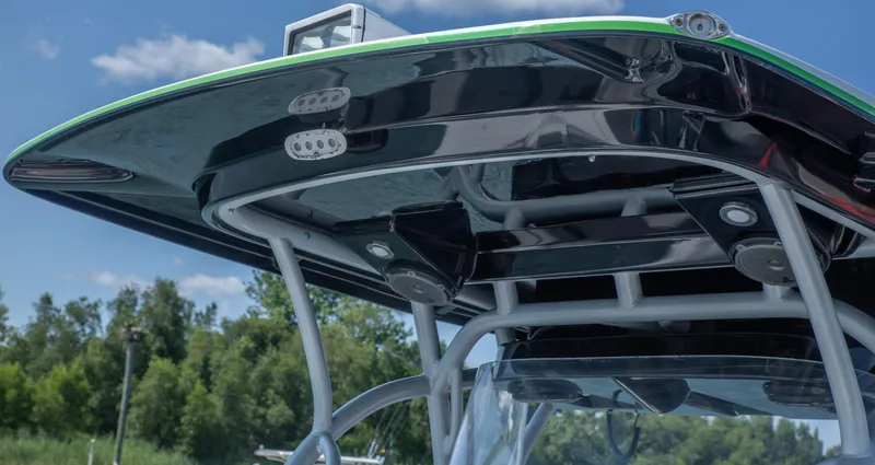 Slide: The Image of 2014 Nor-Tech 390 Sport Cuddy Center Console boat with sleek black canopy. - 9