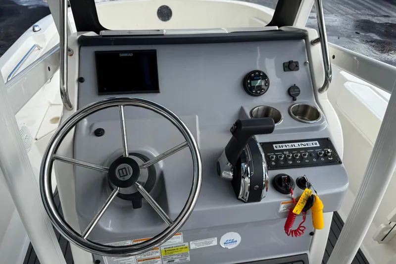 Slide: The Image of 2023 Bayliner Trophy T20CC boat console with steering wheel and controls. - 11