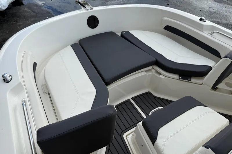 Slide: The Image of 2023 Bayliner Trophy T20CC boat interior with cushioned seating and sleek design. - 14
