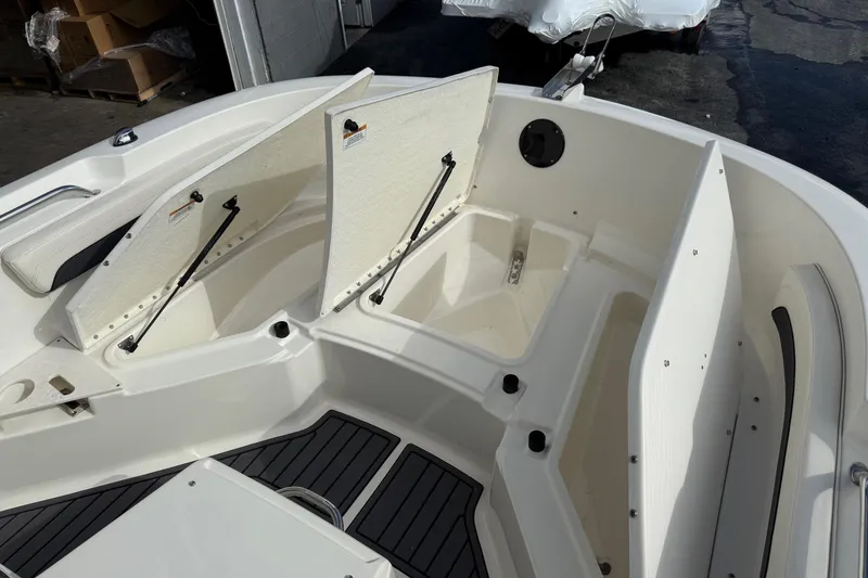 Slide: The Image of 2023 Bayliner Trophy T20CC boat interior with open storage compartments. - 16