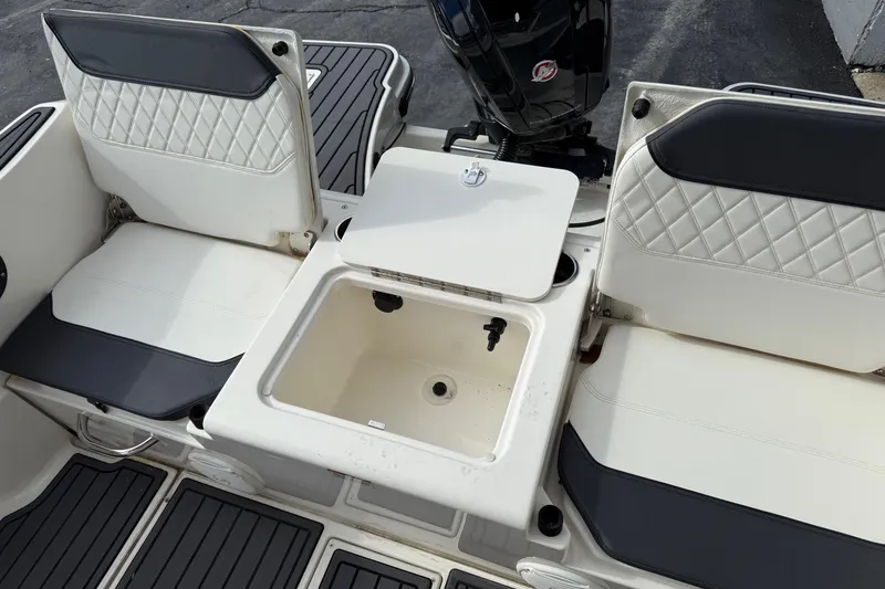 Slide: The Image of 2023 Bayliner Trophy T20CC boat interior with seating and storage compartment. - 7