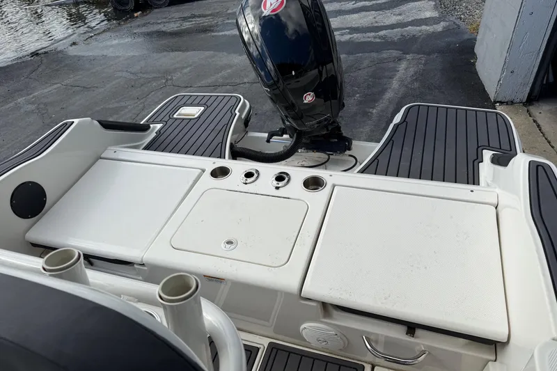 Slide: The Image of 2023 Bayliner Trophy T20CC boat deck with motor and storage compartments. - 8