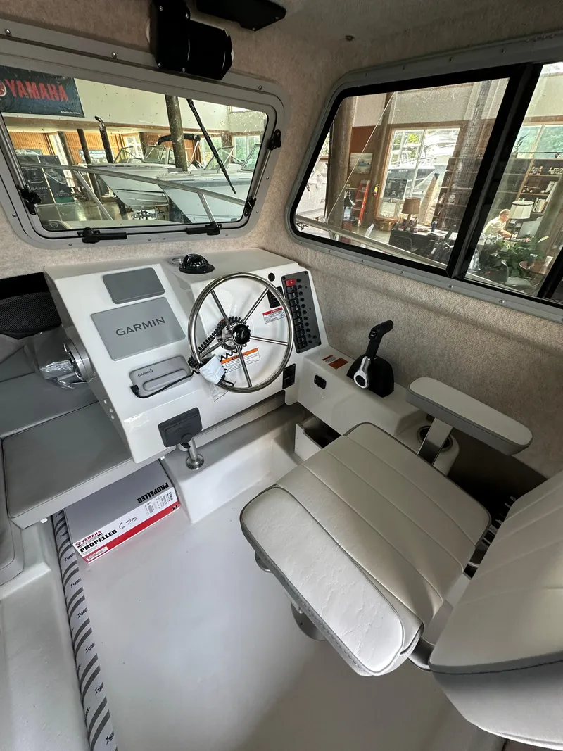 Slide: The Image of 2025 Parker 2120 Sport Cabin interior with steering wheel and Garmin navigation system. - 10