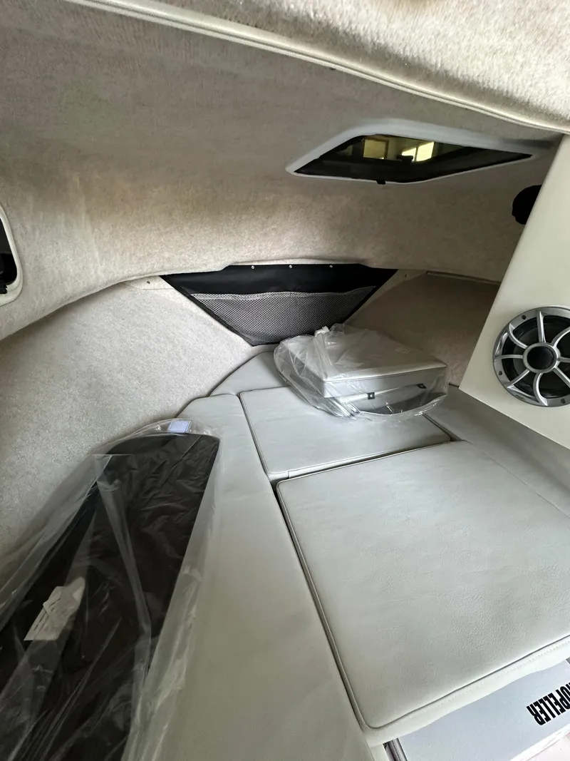 Slide: The Image of 2025 Parker 2120 Sport Cabin interior with cushioned seating and speaker system. - 11