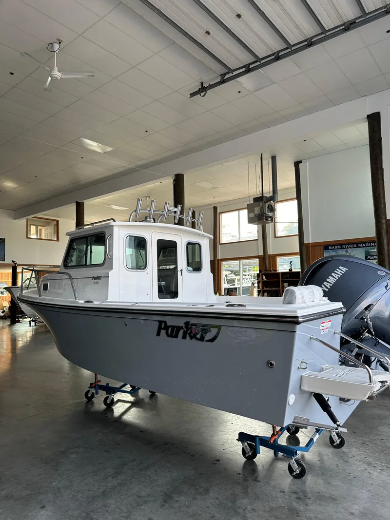 Slide: The Image of 2025 Parker 2120 Sport Cabin boat in showroom with Yamaha engine. - 3