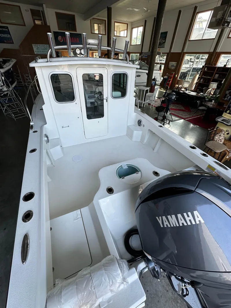 Slide: The Image of 2025 Parker 2120 Sport Cabin boat with Yamaha engine in showroom. - 6