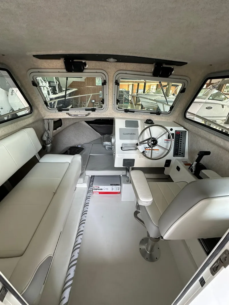 Slide: The Image of 2025 Parker 2120 Sport Cabin interior with steering wheel and seating. - 9