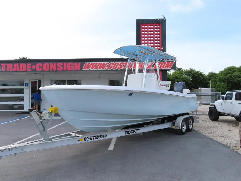 Slide: The Image of 2024 Contender 24S boat on trailer outside dealership. - 0