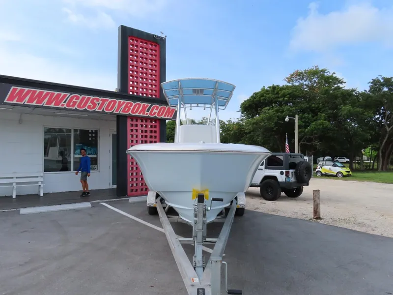Slide: The Image of 2024 Contender 24S boat on trailer outside Gustoybox store. - 1