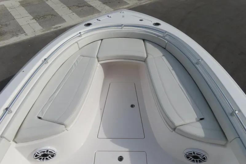 Slide: The Image of 2024 Contender 24S boat bow with cushioned seating and speakers. - 15