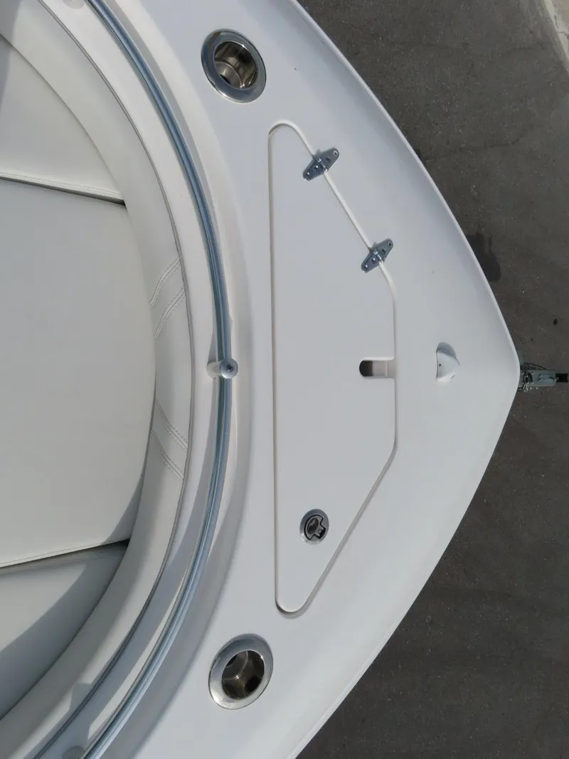 Slide: The Image of 2024 Contender 24S boat deck with storage compartment and stainless steel fixtures. - 16