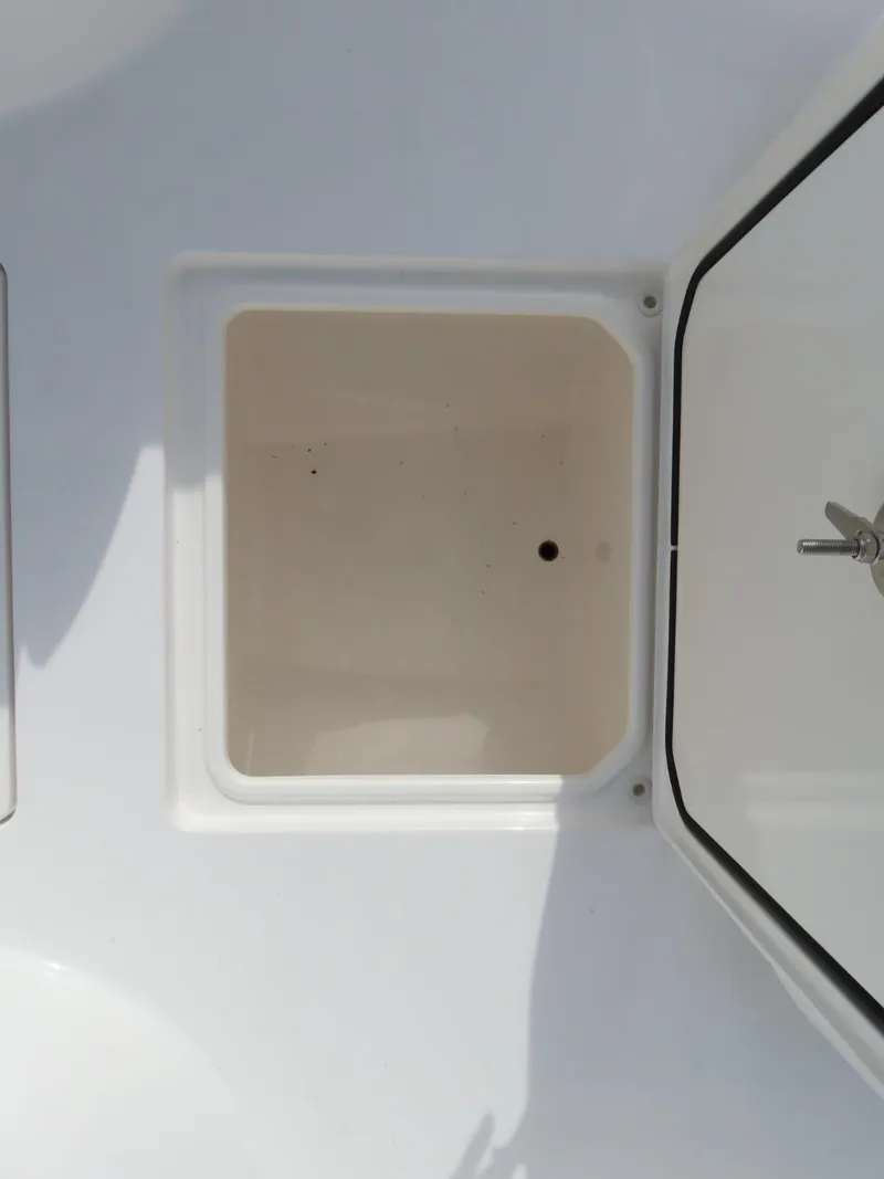 Slide: The Image of 2024 Contender 24S boat storage compartment with open hatch. - 21