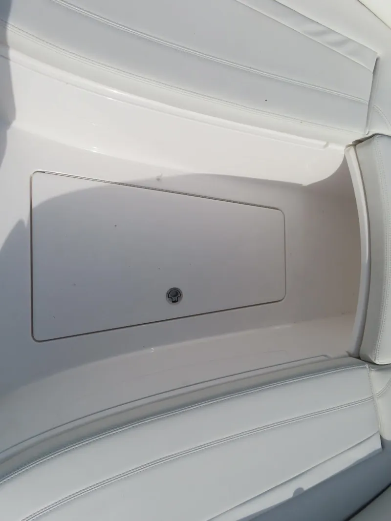 Slide: The Image of 2024 Contender 24S boat interior storage compartment, white finish. - 24