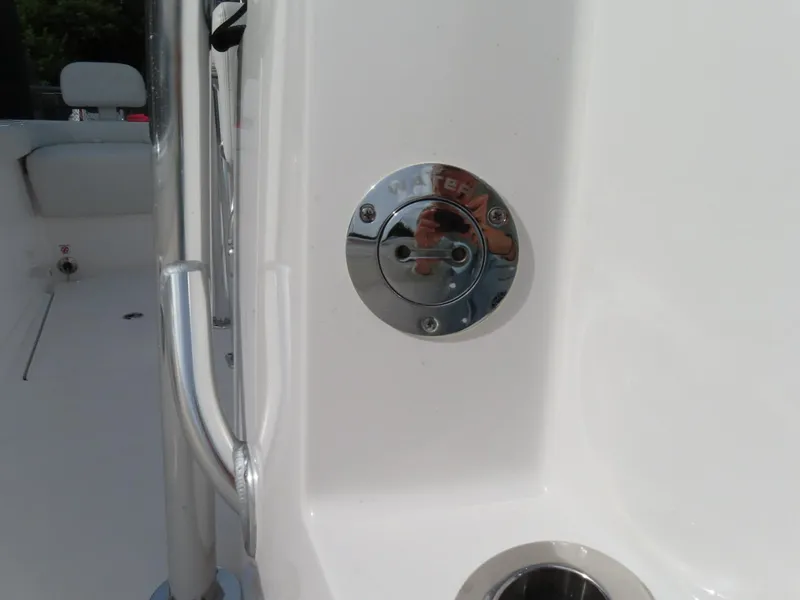 Slide: The Image of 2024 Contender 24S boat interior detail with chrome fixture and railing. - 25