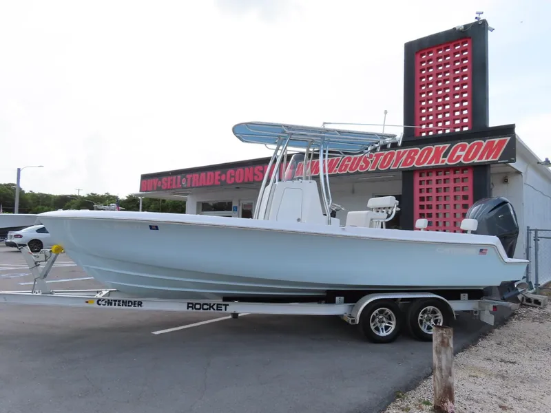 Slide: The Image of 2024 Contender 24S boat on trailer outside dealership. - 3