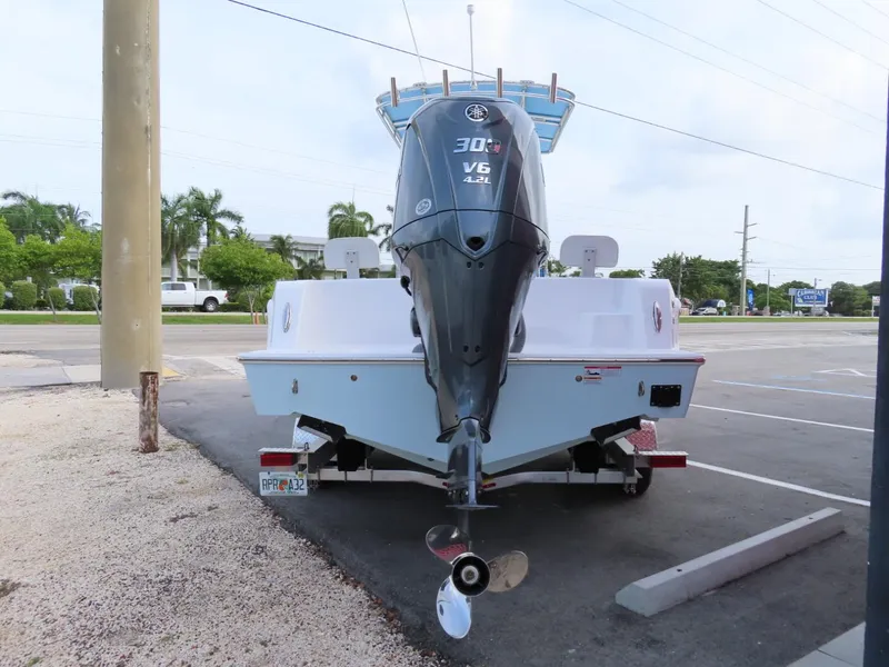 Slide: The Image of 2024 Contender 24S boat with V6 engine on trailer in parking lot. - 4