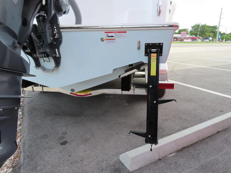 Slide: The Image of 2024 Contender 24S boat trailer with support jack in parking lot. - 5