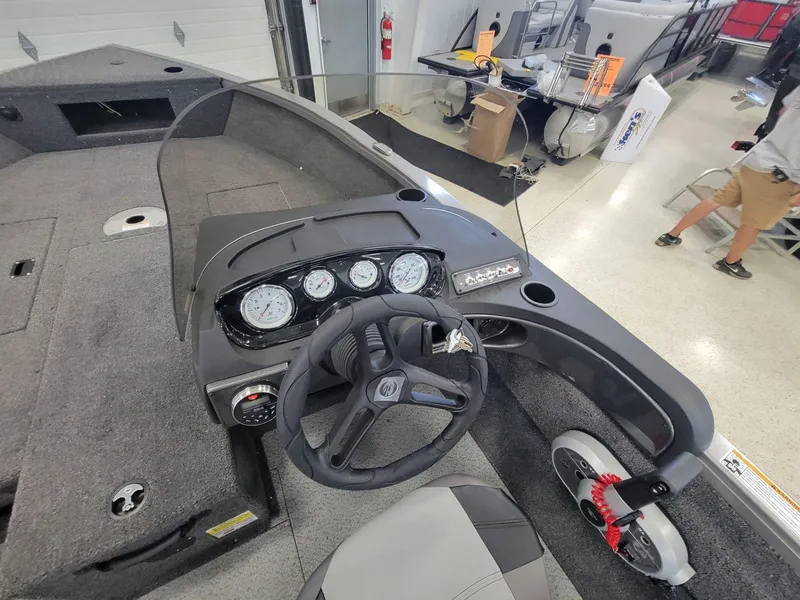Slide: The Image of 2024 Crestliner 1750 HAWK SC JS boat dashboard with steering wheel and gauges. - 11