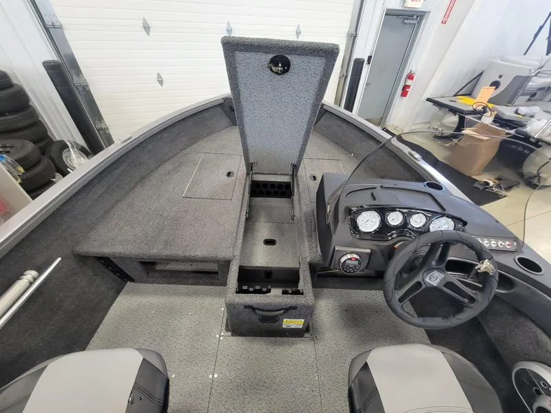 Slide: The Image of 2024 Crestliner 1750 HAWK SC JS boat interior with steering console and storage compartments. - 12