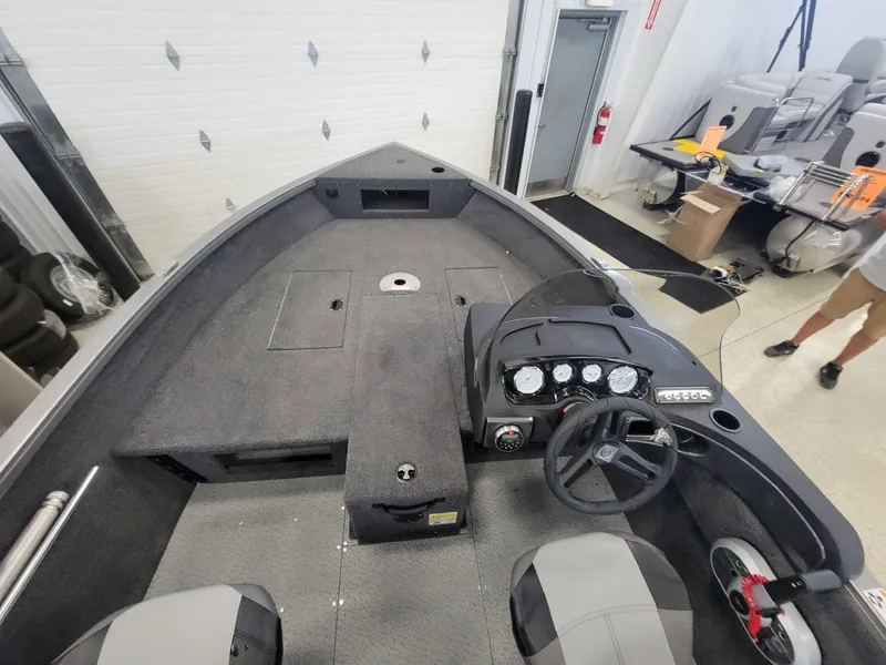 Slide: The Image of 2024 Crestliner 1750 HAWK SC JS boat interior with steering console and seating. - 8