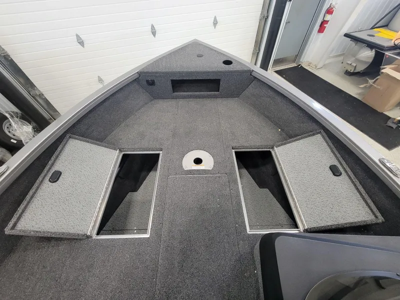 Slide: The Image of 2024 Crestliner 1750 HAWK SC JS boat interior with open storage compartments. - 9