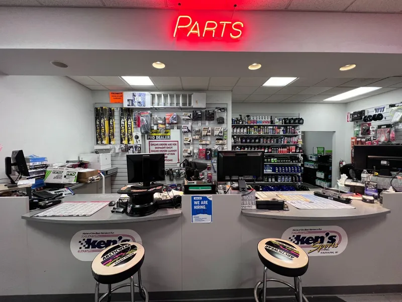 Slide: The Image of Parts counter in a store with neon sign, featuring Sea-Doo RXT-X 300 accessories. - 12