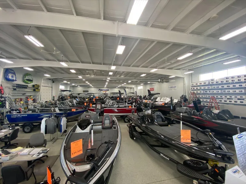 Slide: The Image of Boat showroom with various models, including 2019 Sea-Doo RXT-X 300 iBR, displayed for sale. - 14