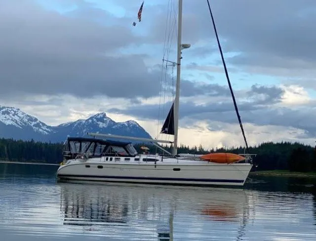 The Image of Sailboat Hunter 460 (2000) on calm water with mountain backdrop. - 0