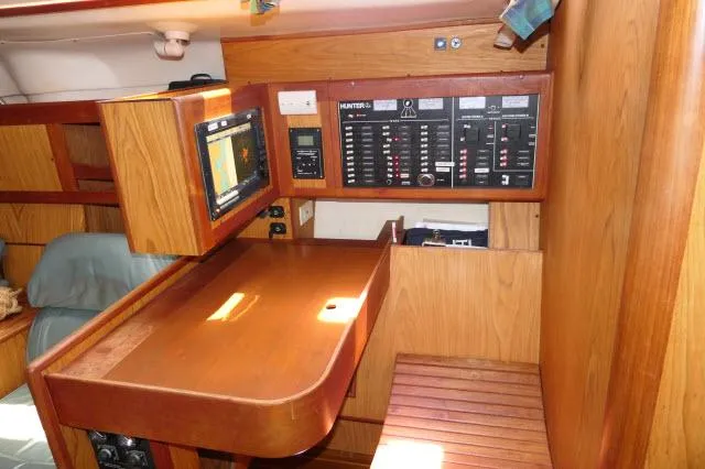 Slide: The Image of Navigation station in a 2000 Hunter 460 sailboat with control panel and chart plotter. - 17