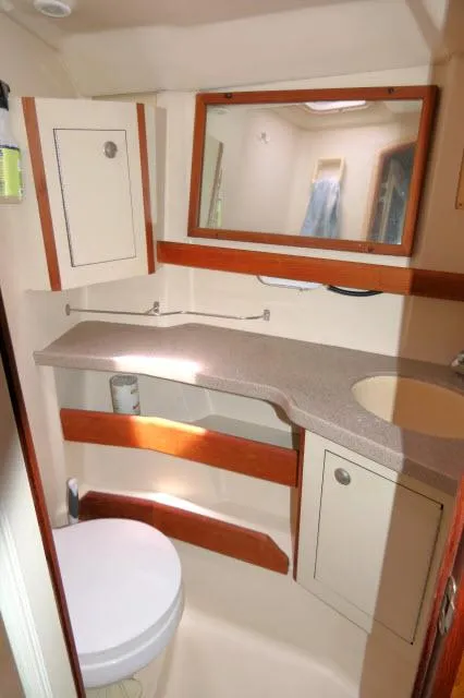Slide: The Image of Compact bathroom in 2000 Hunter 460 yacht with sink, mirror, and toilet. - 25
