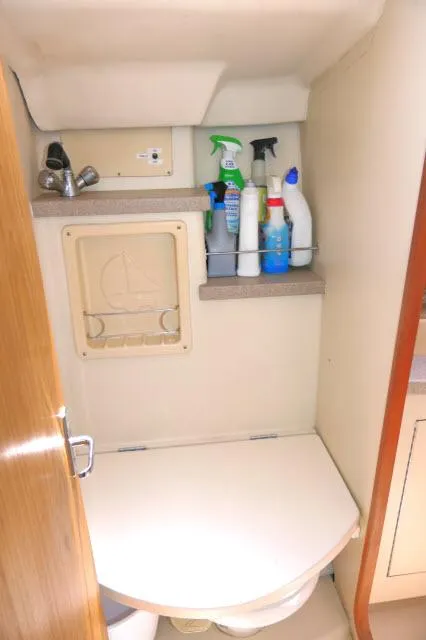 Slide: The Image of Compact bathroom in 2000 Hunter 460 yacht with cleaning supplies on shelf. - 32