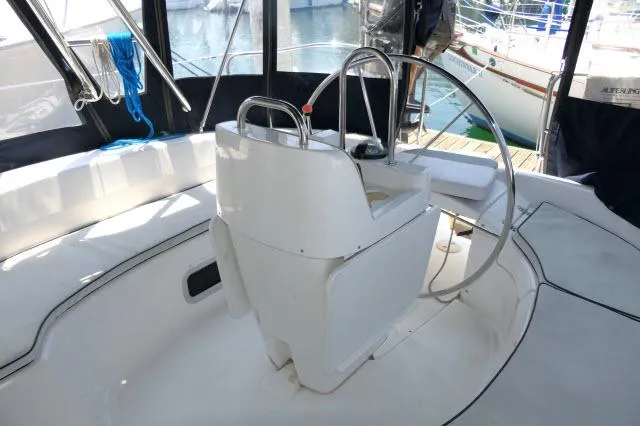 Slide: The Image of Cockpit of 2000 Hunter 460 sailboat with steering wheel and seating. - 37