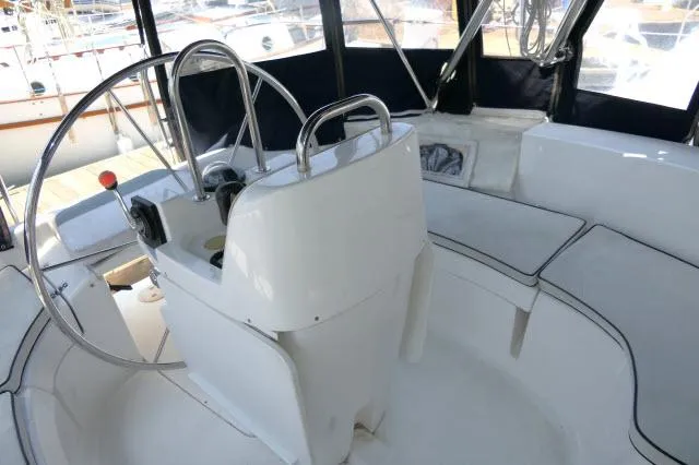 Slide: The Image of Interior view of 2000 Hunter 460 sailboat cockpit with steering wheel and seating. - 38