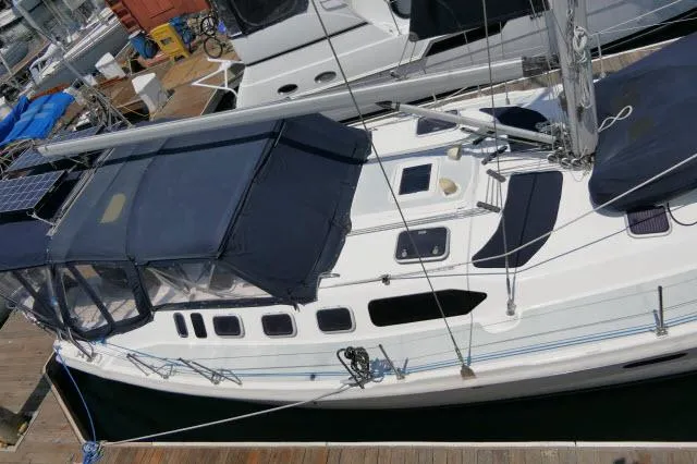 Slide: The Image of Hunter 460 sailboat, 2000 model, docked at marina with blue canopy. - 45