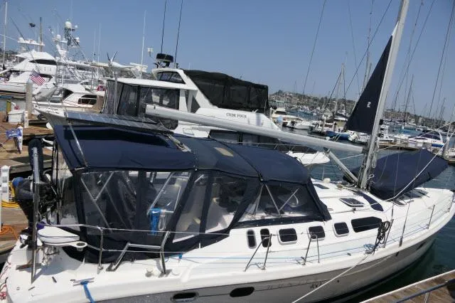 Slide: The Image of Hunter 460 sailboat from 2000 docked in a marina with other boats. - 46