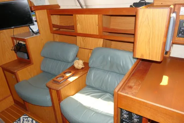 Slide: The Image of Interior of 2000 Hunter 460 yacht with blue leather seating and wooden cabinetry. - 5