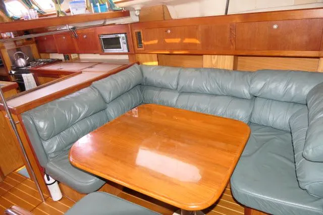Slide: The Image of Cozy interior of 2000 Hunter 460 yacht with leather seating and wooden table. - 8