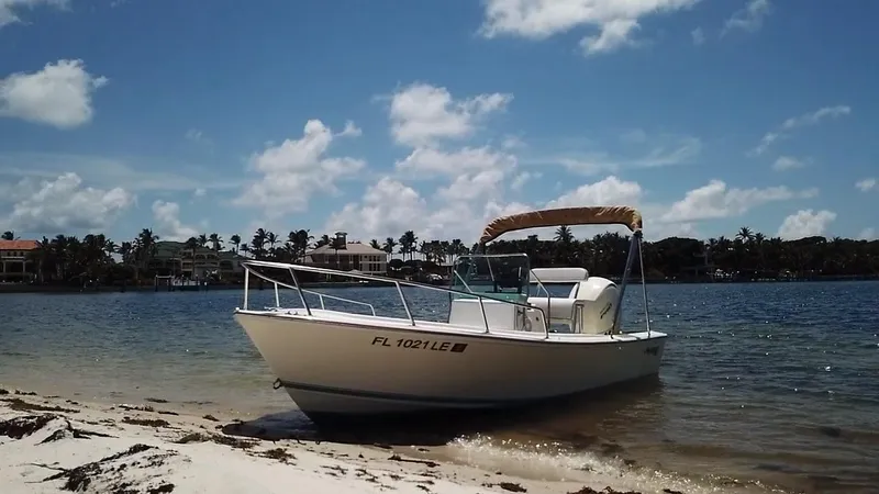 Slide: The Image of 1984 Aquasport 17 CC boat on sandy beach under clear blue sky. - 11