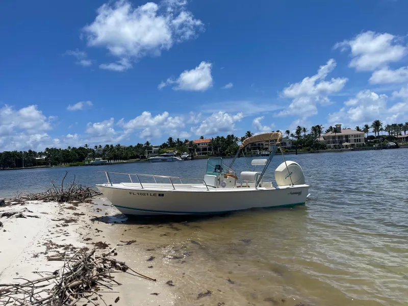 Slide: The Image of 1984 Aquasport 17 CC boat on sandy shore under blue sky. - 4
