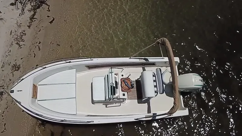 Slide: The Image of 1984 Aquasport 17 CC boat docked on sandy shore, aerial view. - 6