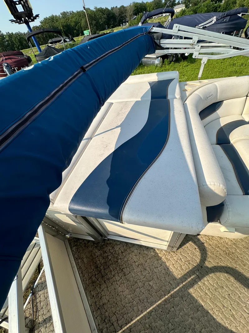 Slide: The Image of 2008 Misty Harbor 2085GM Grand Mistique boat with blue and white seating, outdoor setting. - 11