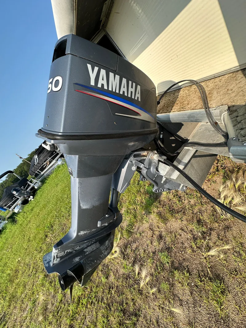 Slide: The Image of Yamaha outboard motor on 2008 Misty Harbor 2085GM Grand Mistique boat, parked on grass. - 14